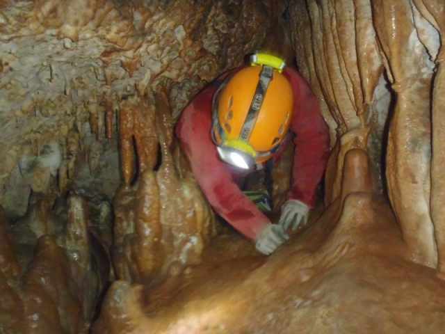  Man entering the caves with his helmet on 